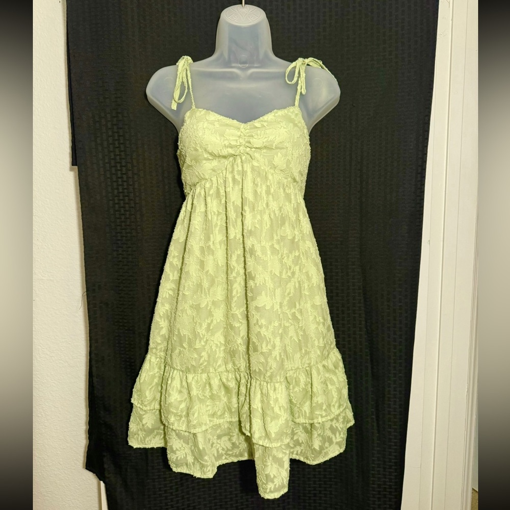 Green spaghetti strap dress with adjustable ties & floral pattern